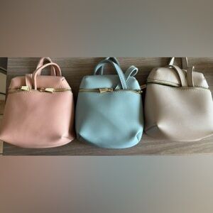 Plain colored cute bags, never used except for the light brown one (barely).